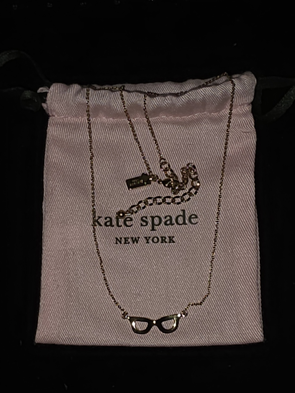 kate spade gold eyeglass necklace with pink pouch